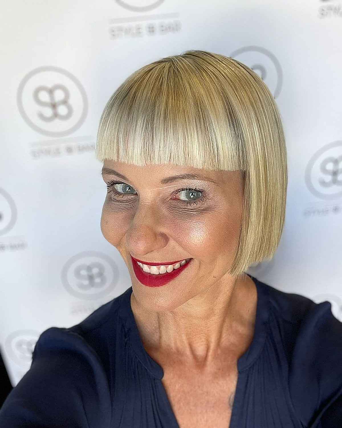 sleek french bob with blunt bangs for woman over 40 with fine hair