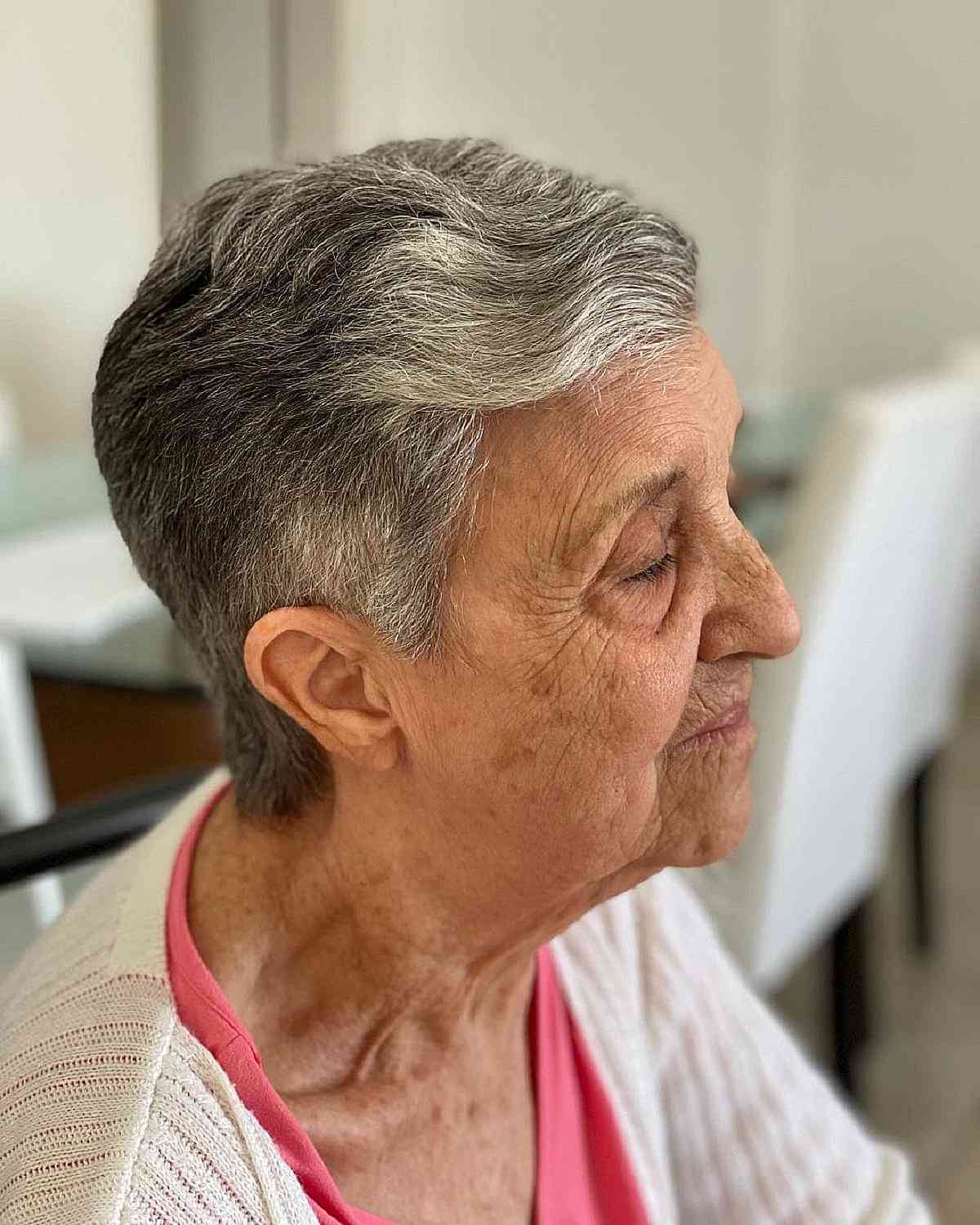 slicked back style on short grey hair for 70 year old women