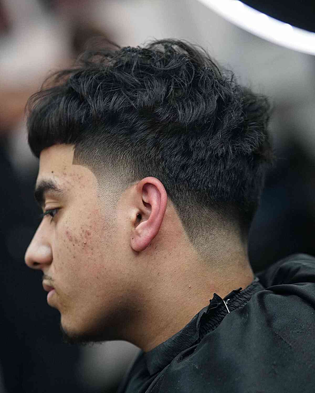 tousled edgar style with low drop fade on men