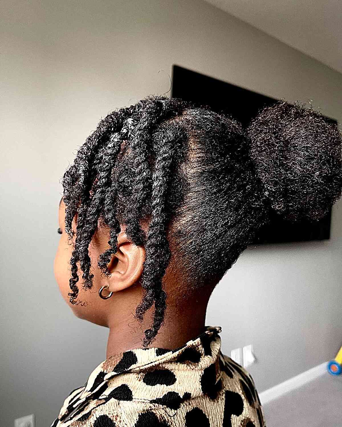 two strand twists and a natural bun for black schoolgirls