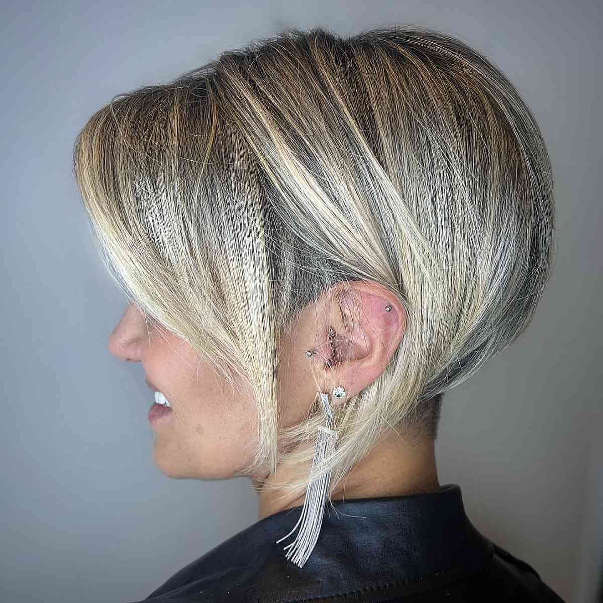 undercut blonde pixie bob hair with dark roots