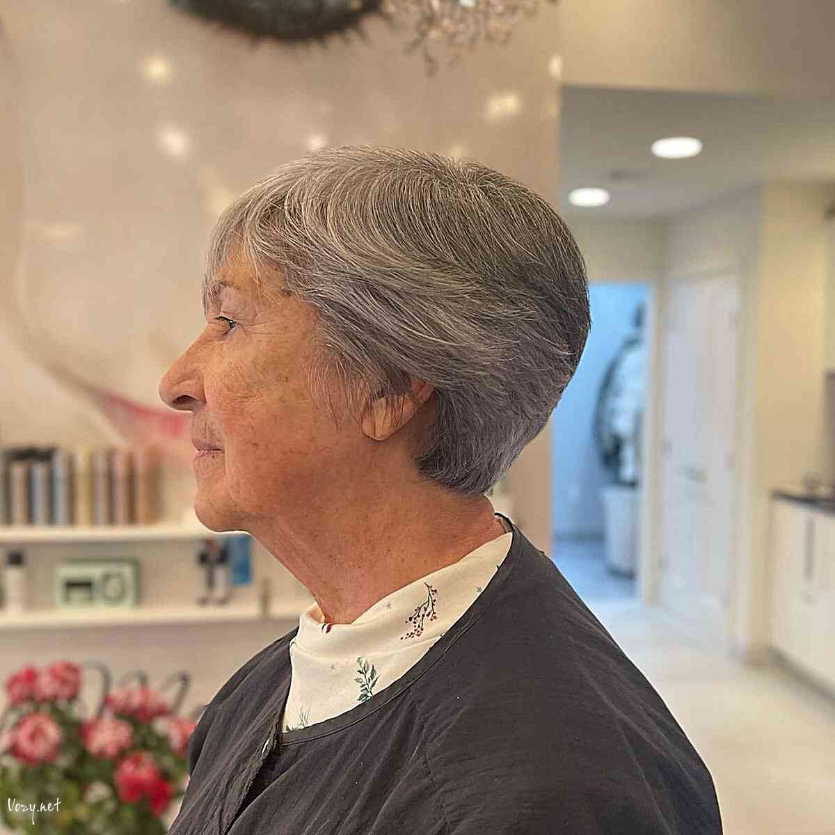 very short grey feathery stacked pixie on women over sixty