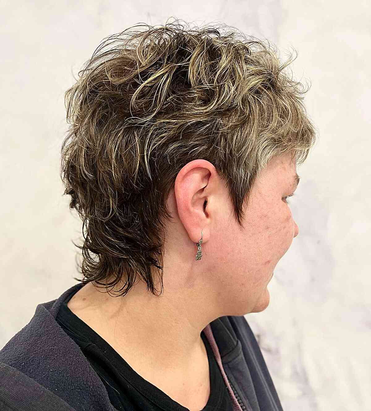 very short mullet shag with blonde highlights for older women