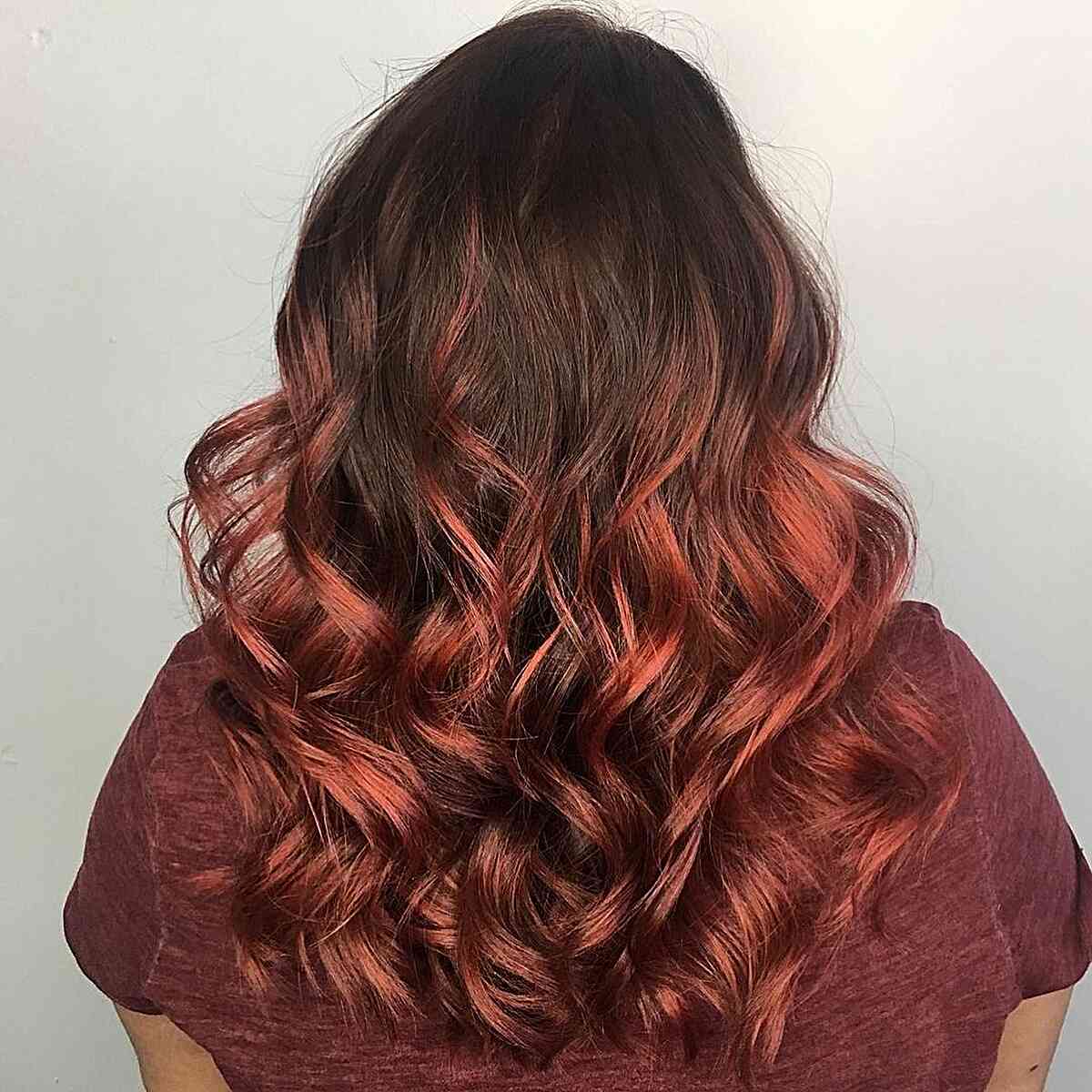 vibrant copper red balayage on dark brown hair