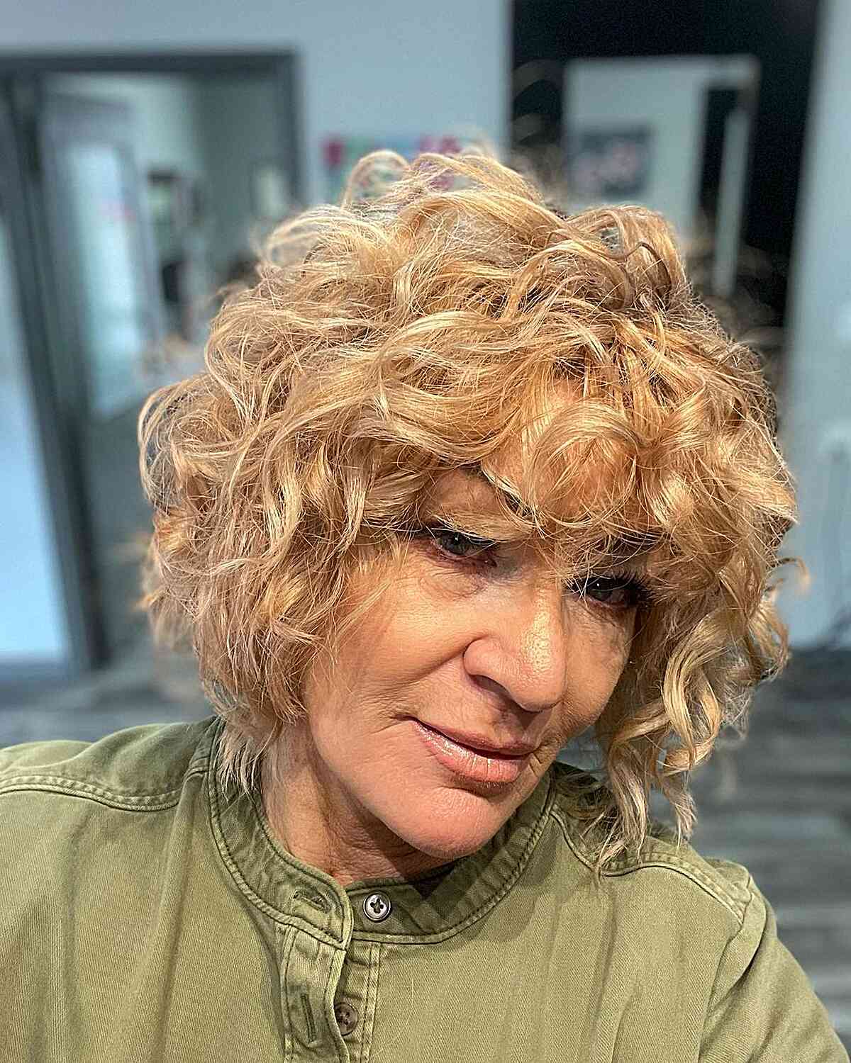 voluminous layered bob with bangs and curls for senior women