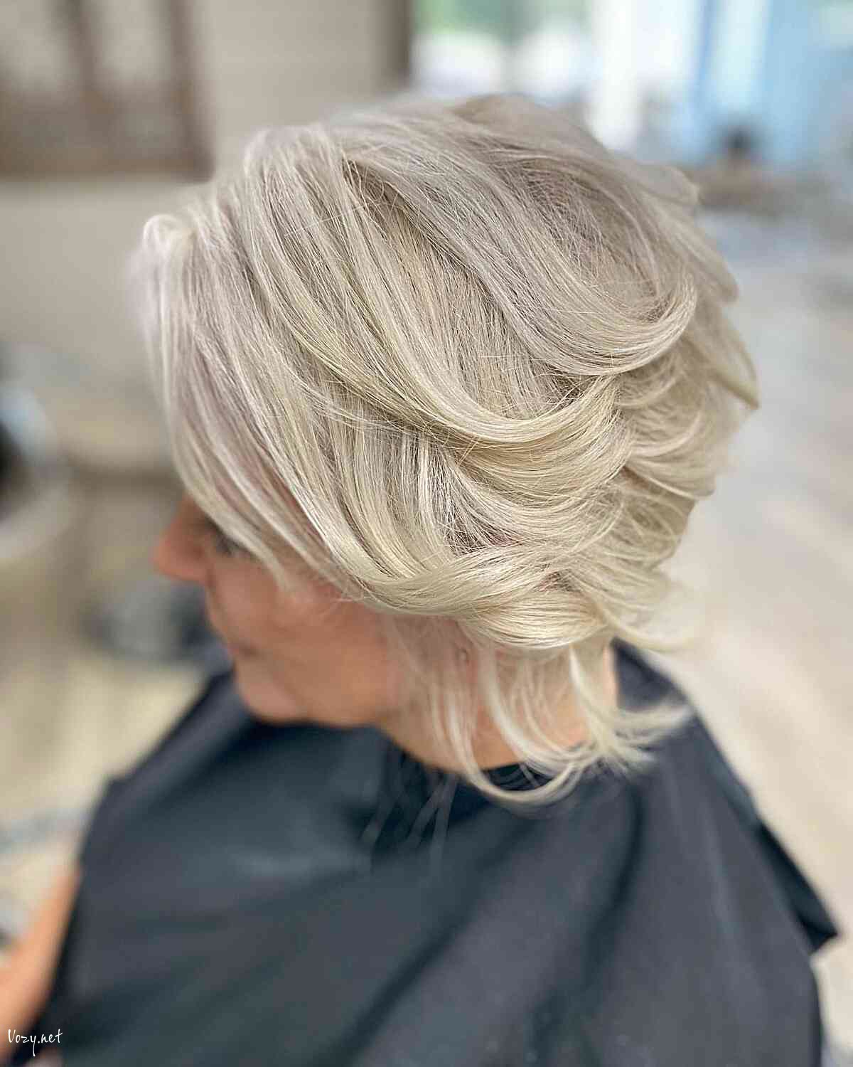 wavy platinum bob with feathered flicked layers for 60 year olds