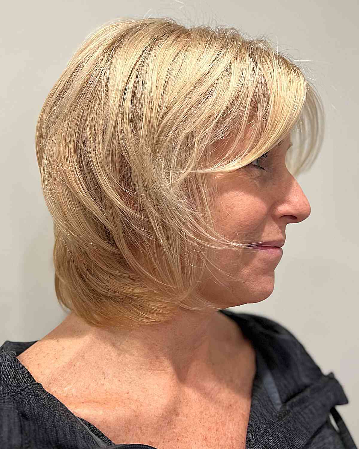 wispy shag with face framing bangs for fine haired mature women