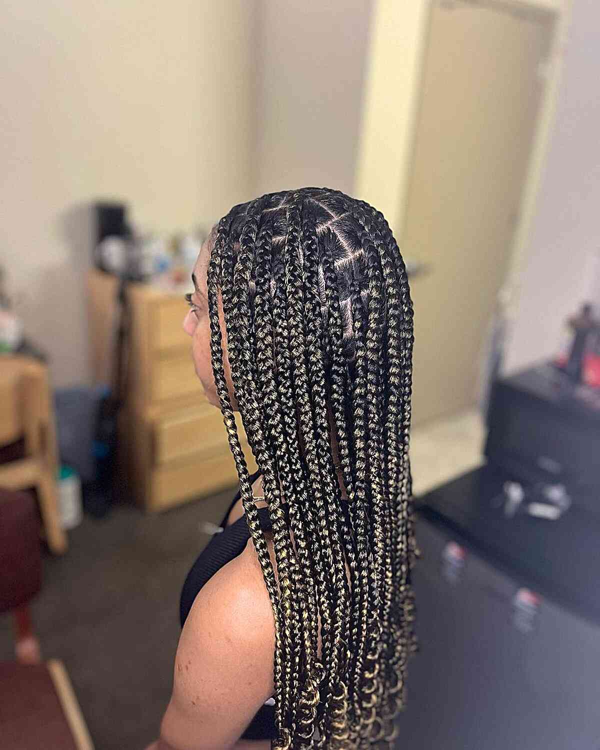 medium knotless braids with subtle blonde highlights