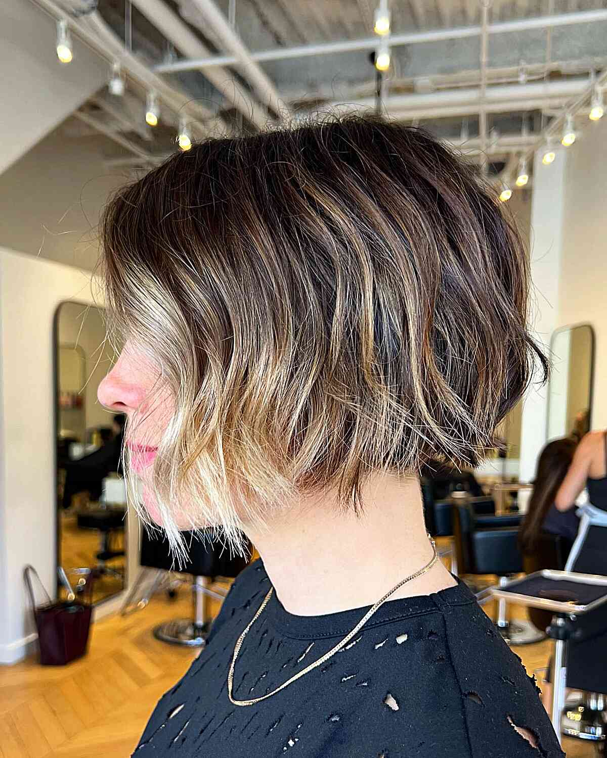 mini brown textured bob with face framing highlights