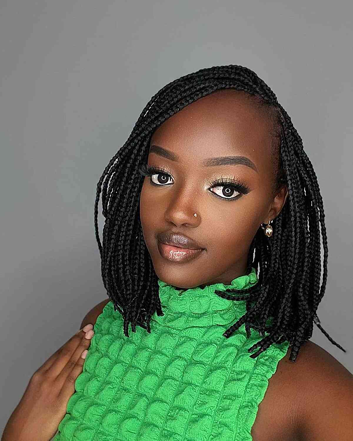 shoulder length mini knotless braids with deep side part style