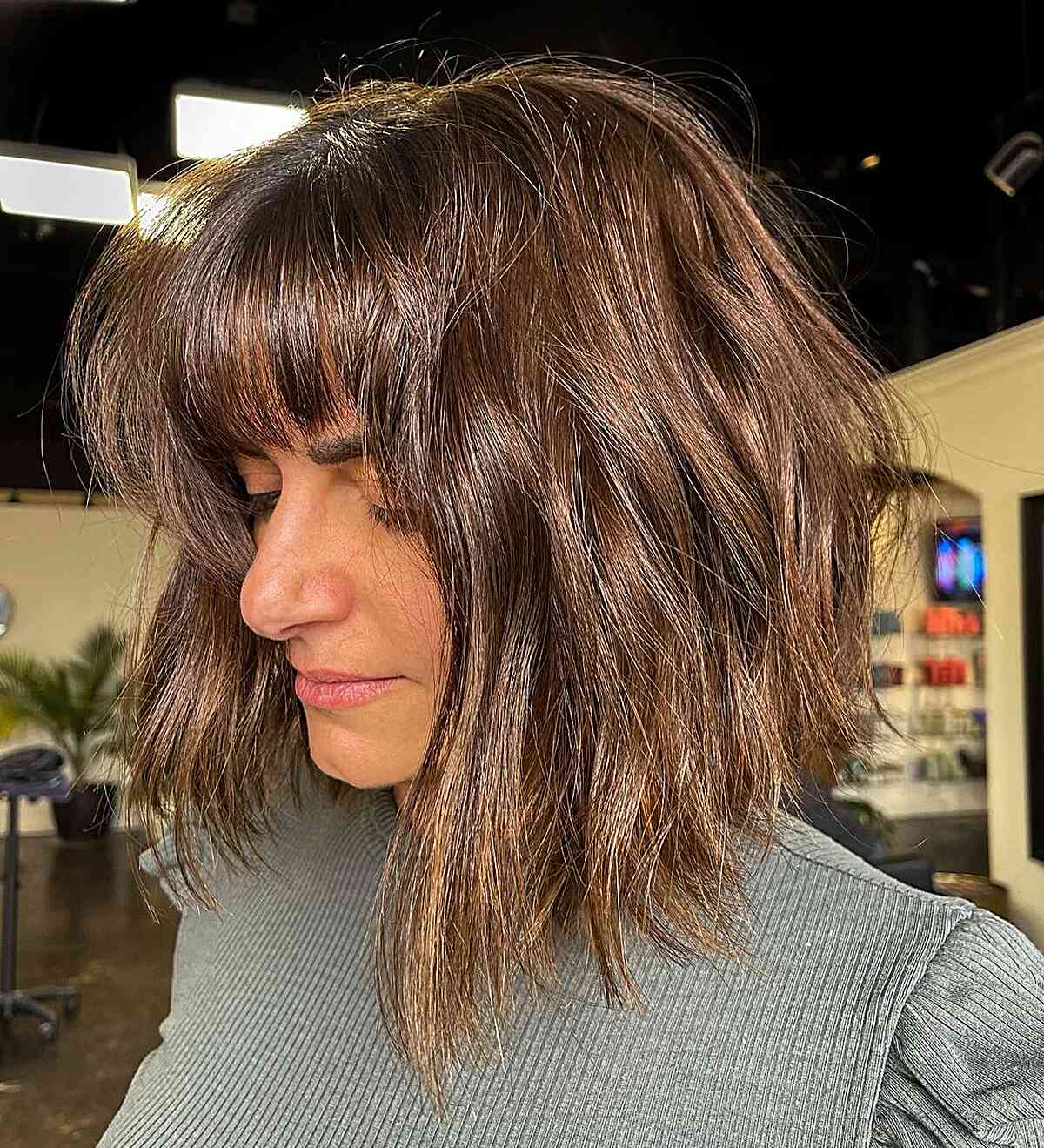 tousled textured long bob with straight bangs